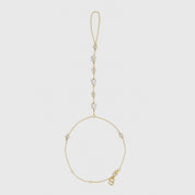 14k gold plated hand chain bracelet with round-cut and teardrop-cut cubic zirconia detailing, shown on a plain background.