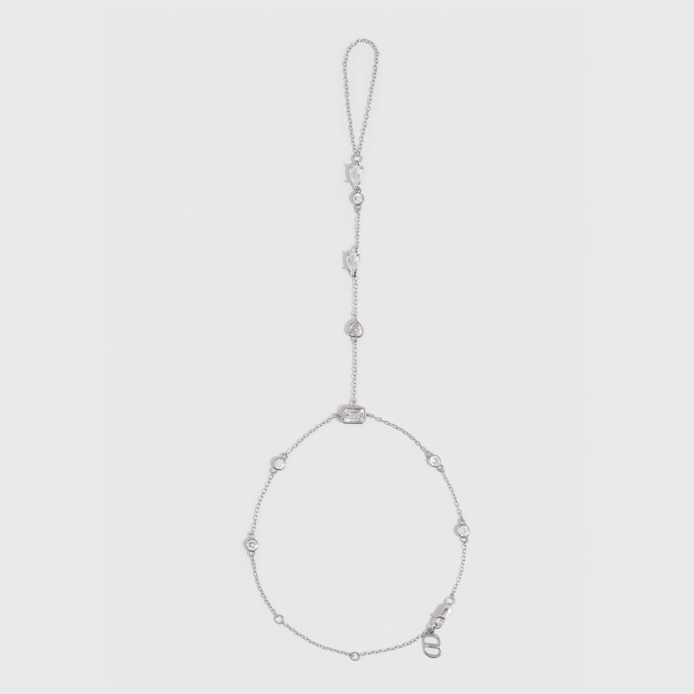 Silver hand chain bracelet with five different cubic zirconia cut styles, shown on a plain background.