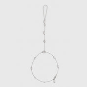 Silver hand chain bracelet with five different cubic zirconia cut styles, shown on a plain background.