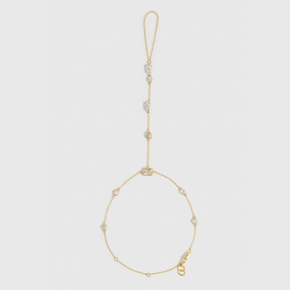 14k gold plated hand chain bracelet with five different cubic zirconia cut styles, shown on a plain background.