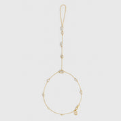 14k gold plated hand chain bracelet with five different cubic zirconia cut styles, shown on a plain background.