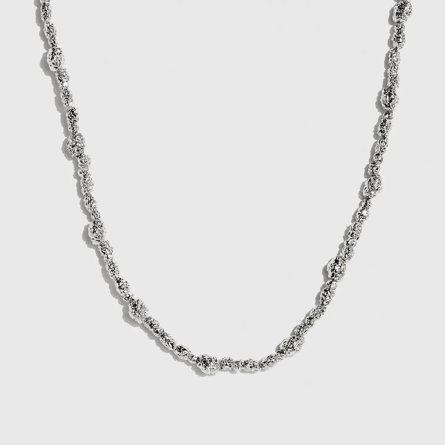 Silver beaded nugget necklace with 4mm beads strung along the chain, shown on a plain background.