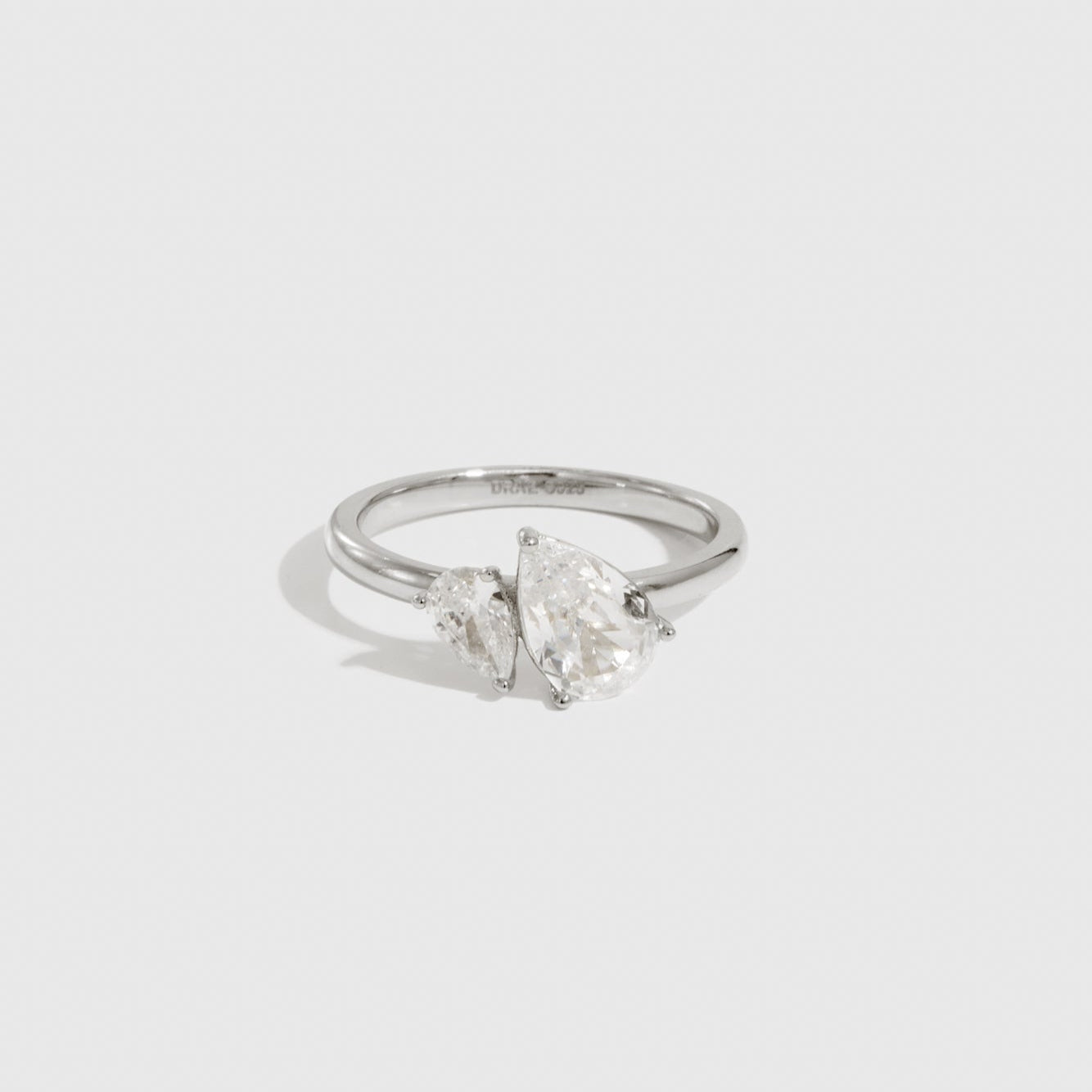 Sterling silver 925 double teardrop-cut CZ ring with two teardrop-cut cubic zirconia, shown on a plain background.