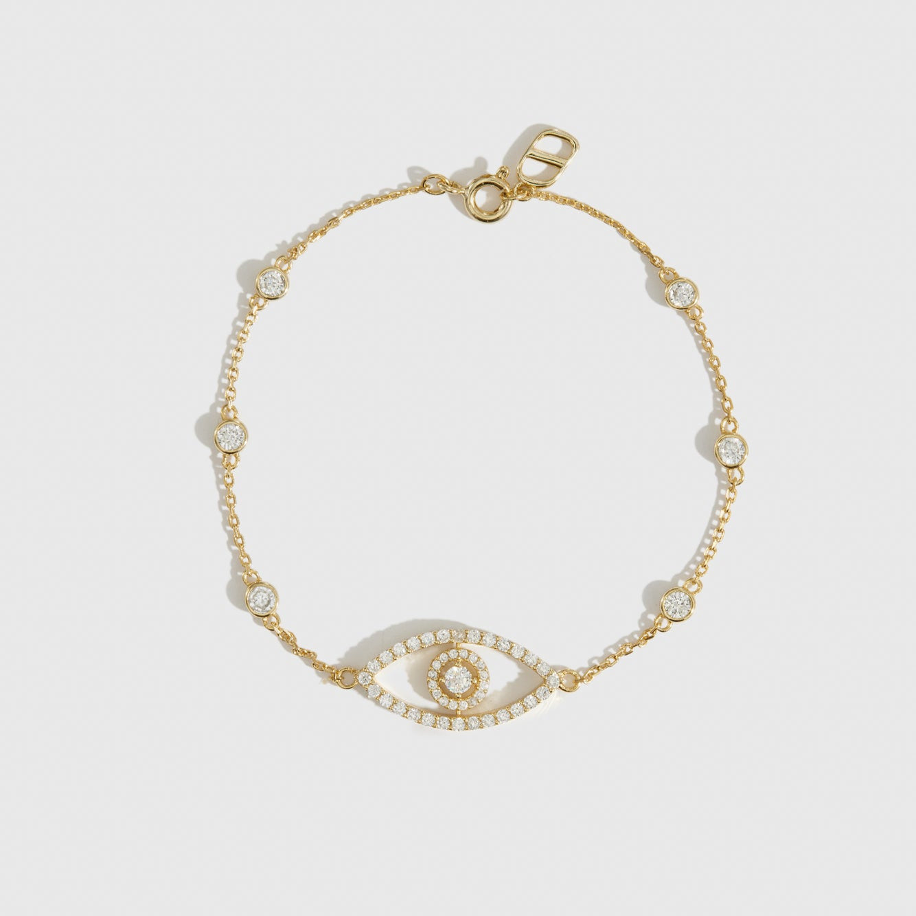 14k gold plated sterling silver 925 evil eye pavé bracelet with cubic zirconia, shown on a plain background.