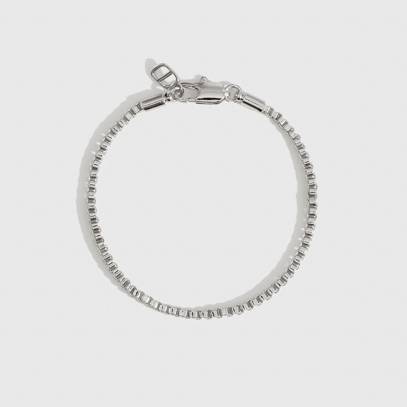 Silver plated square box chain bracelet, shown on a plain background.