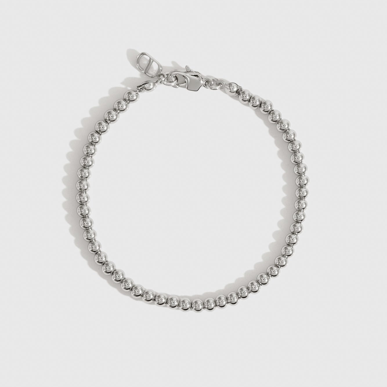 Silver plated small beaded bracelet, shown on a plain background.