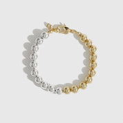 Mixed metal beaded bracelet, shown on a plain background.