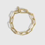14k gold plated maximalist paper clip bracelet with a pavé cubic zirconia clasp, shown on a plain background.