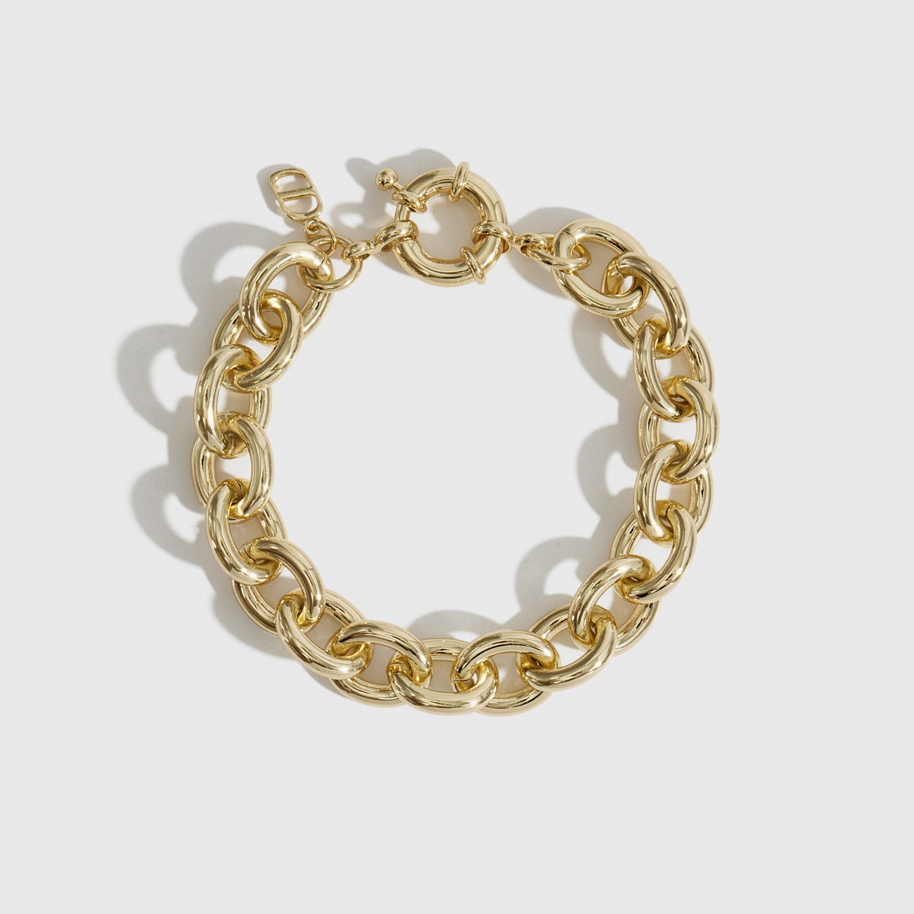 14k gold plated small oval link bracelet, shown on a plain background.