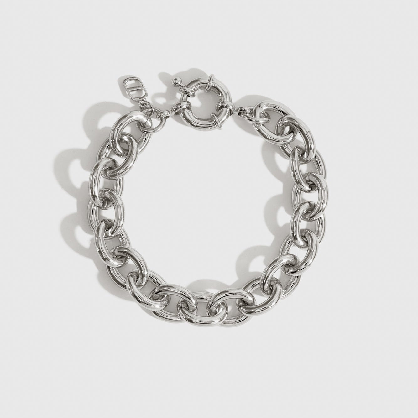 Silver plated small oval link bracelet, shown on a plain background.
