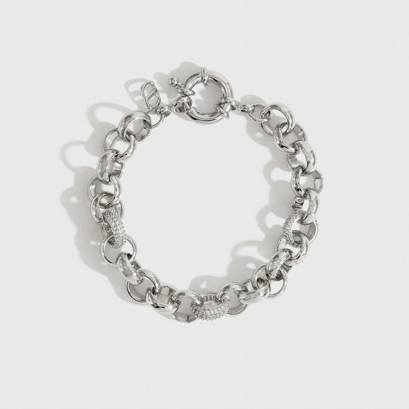 Silver plated maximalist rolo pavé bracelet with pavé cubic zirconia, shown on a plain background.
