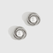 Silver plated mini 90's pearl stud earrings with a pearl, shown on a plain background.