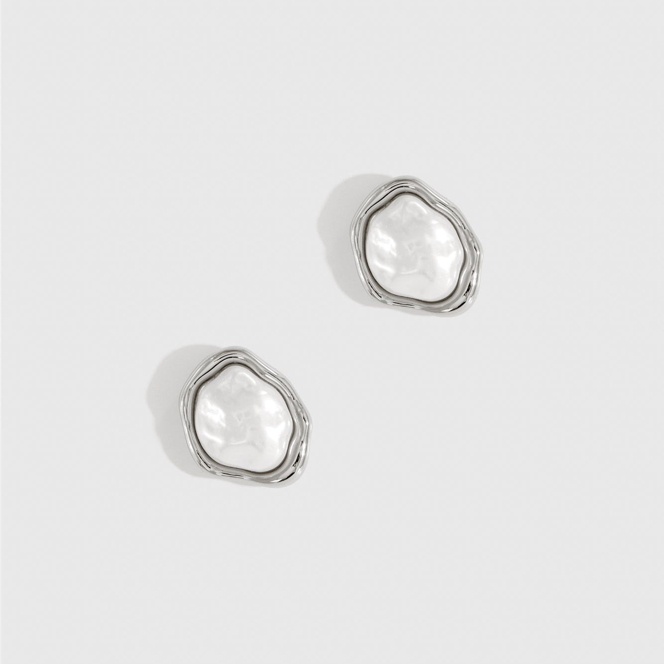 Silver plated baroque pearl stud earrings with a baroque glass pearl, shown on a plain background.