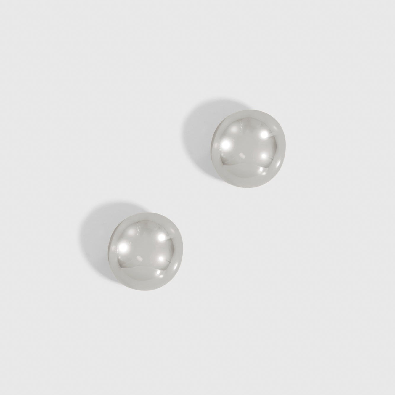 Silver plated mini puffy dome stud earrings, shown on a plain background.