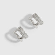 Silver plated double pavé hoop earrings with pavé cubic zirconia, shown on a plain background.