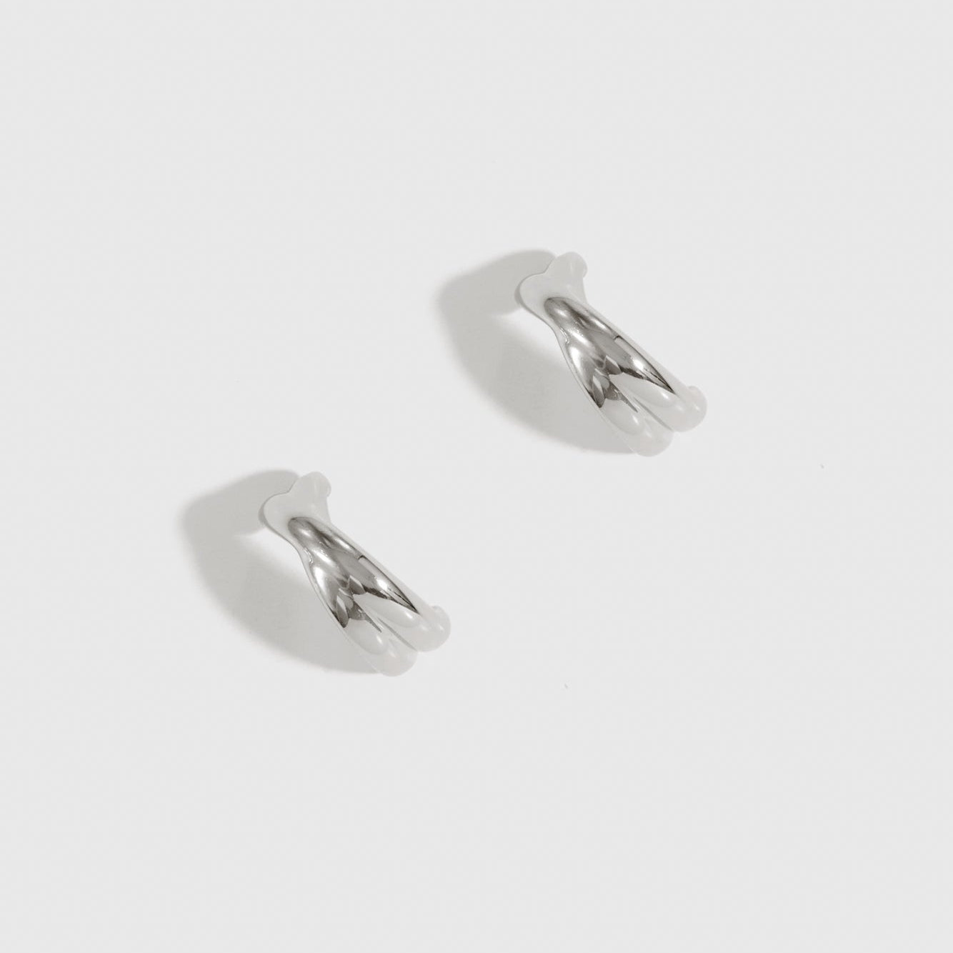 Silver plated X's hoop earrings, shown on a plain background.