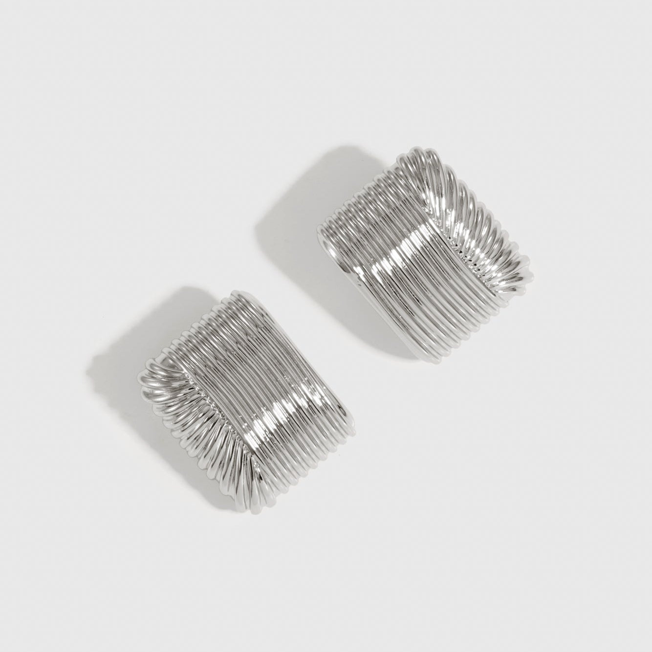 Silver plated bold stud earrings, shown on a plain background.