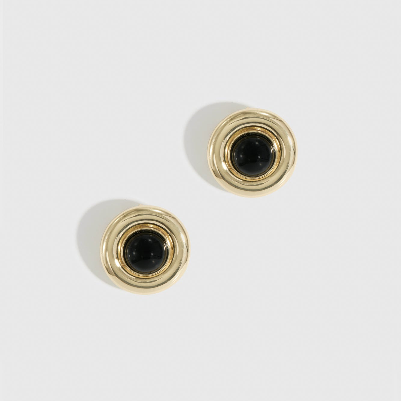14k gold plated black vintage stud earrings with black enamel, shown on a plain background.