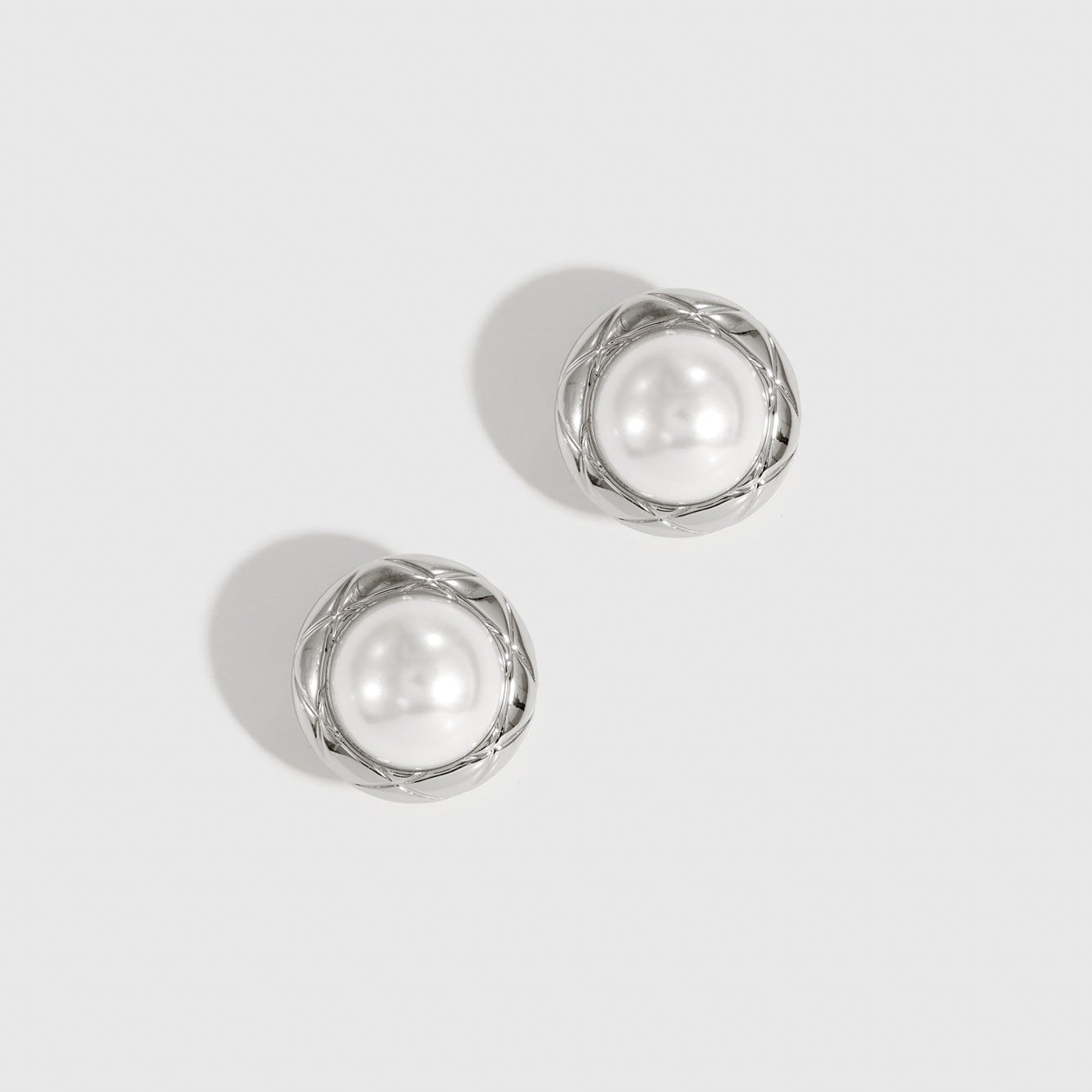 Silver plated Coco stud earrings with a glass pearl, shown on a plain background.