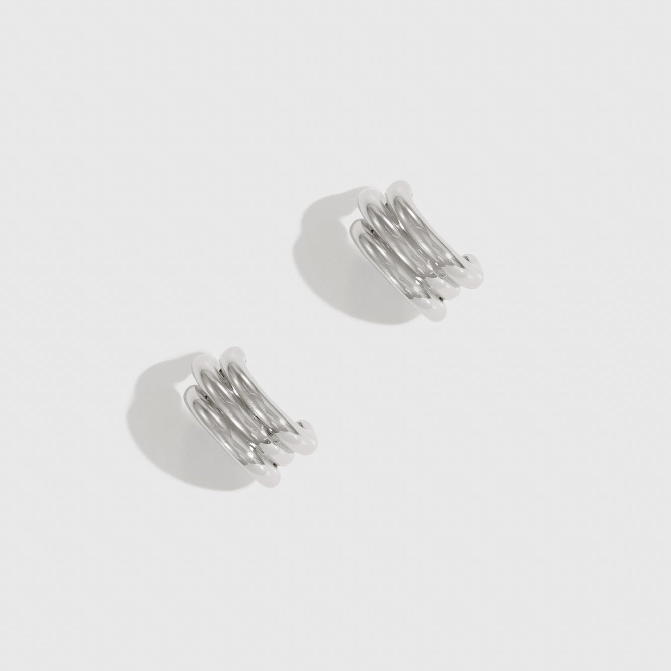 Silver plated triple stud earrings, shown on a plain background.