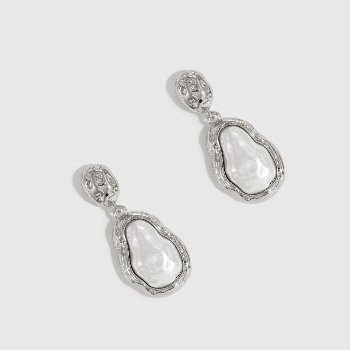 Silver plated pearl pendant earrings with baroque glass pearls, shown on a plain background.