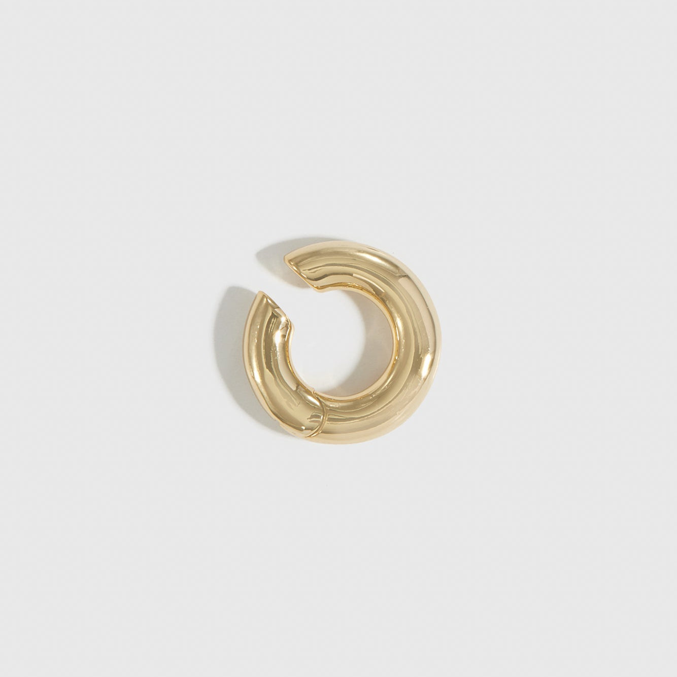 14k gold plated tube ear cuff, shown on a plain background.