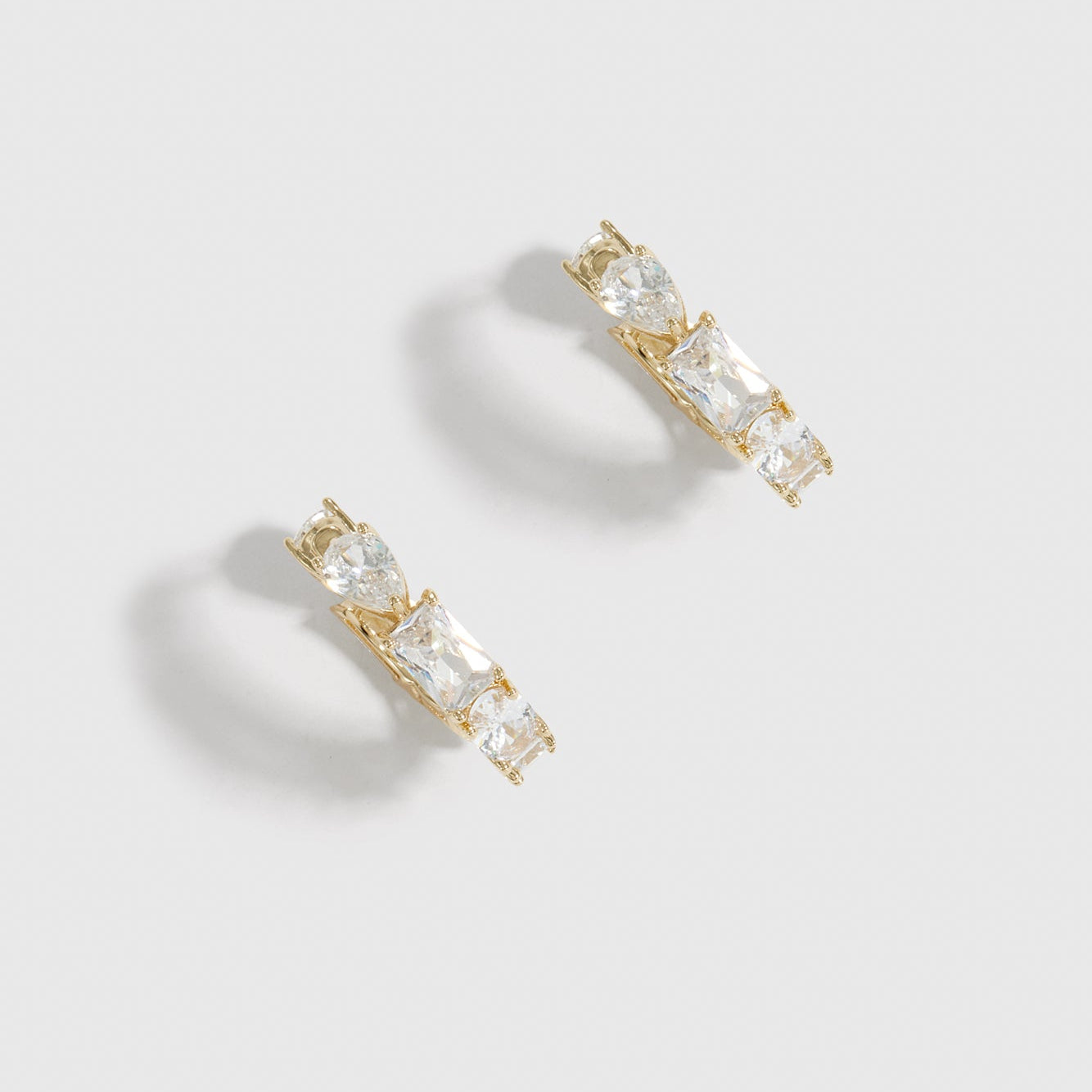 14k gold plated sterling silver 925 Ophélie mini hoop earrings with four cuts of cubic zirconia, shown on a plain background.