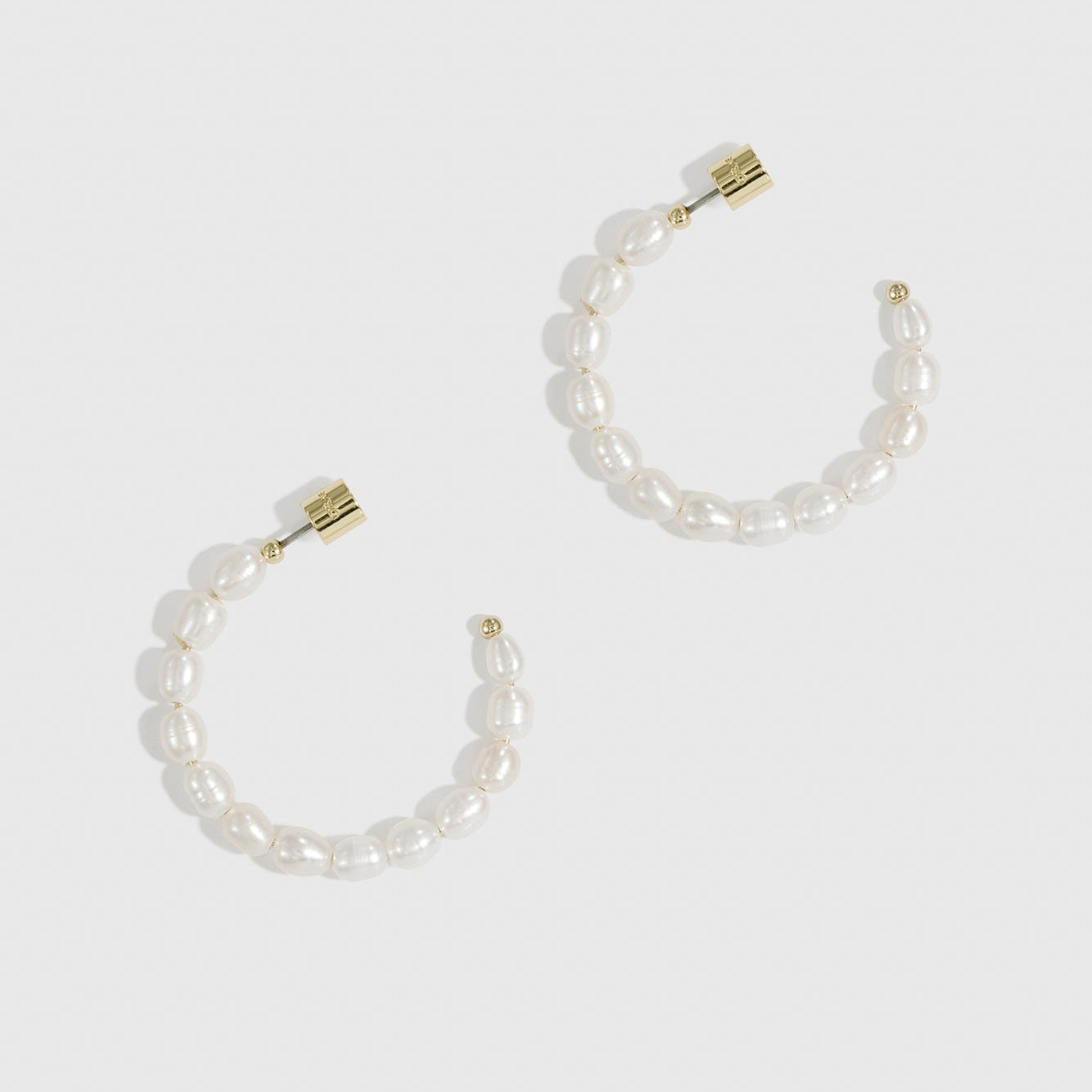 14k gold plated freshwater pearl hoop earrings with freshwater pearls, shown on a plain background.