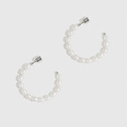 Silver plated freshwater pearl hoop earrings with freshwater pearls, shown on a plain background.
