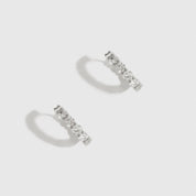 Sterling silver 925 inside-out pavé huggies with cubic zirconia, shown on a plain background.