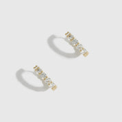 14k gold plated sterling silver 925 inside-out pavé huggies with cubic zirconia, shown on a plain background.