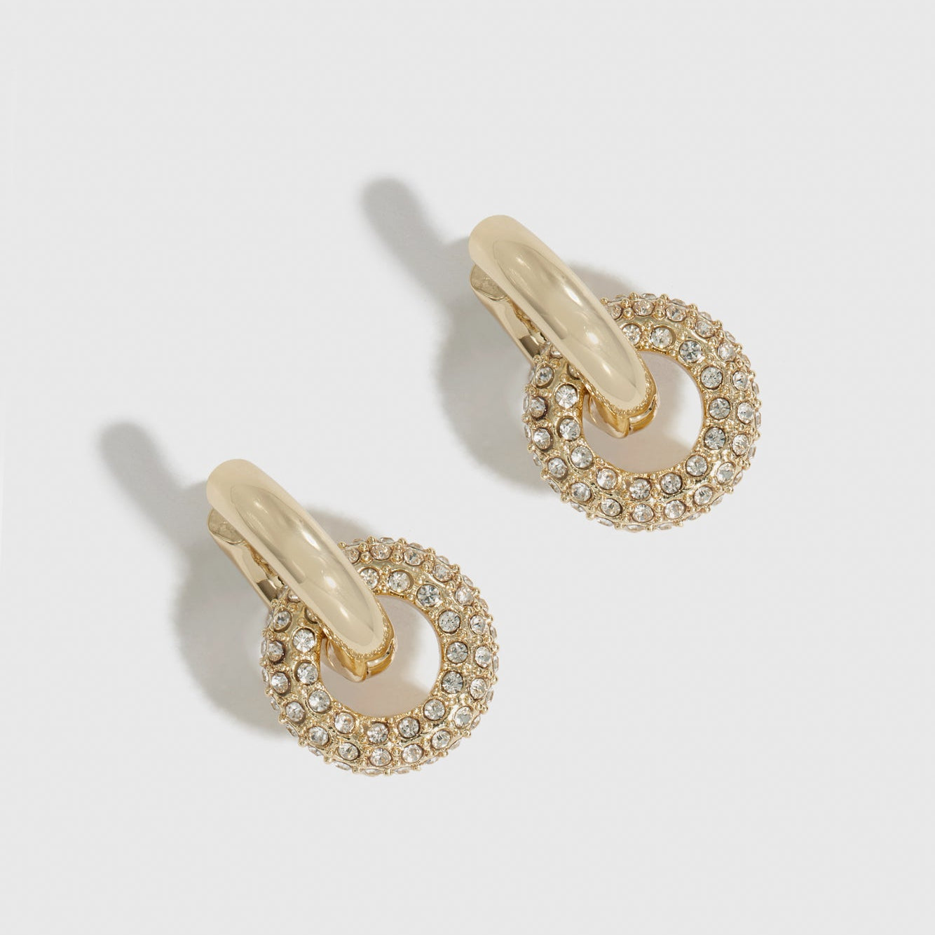 14k gold plated crystal pavé convertible huggies with cubic zirconia crystals, shown on a plain background.