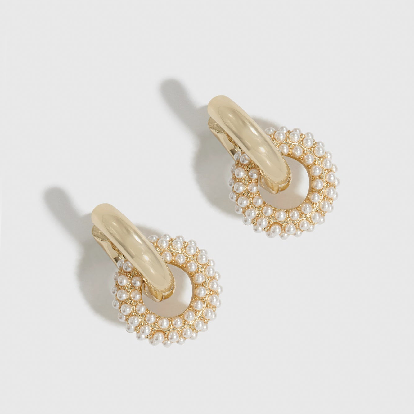14k gold plated pearl pavé convertible huggies with pearls, shown on a plain background.