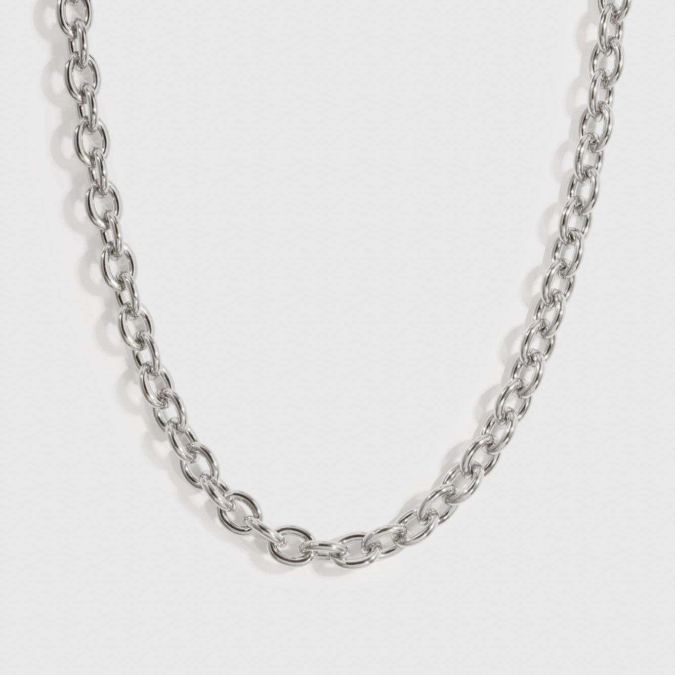 Silver plated small oval link necklace, shown on a plain background.