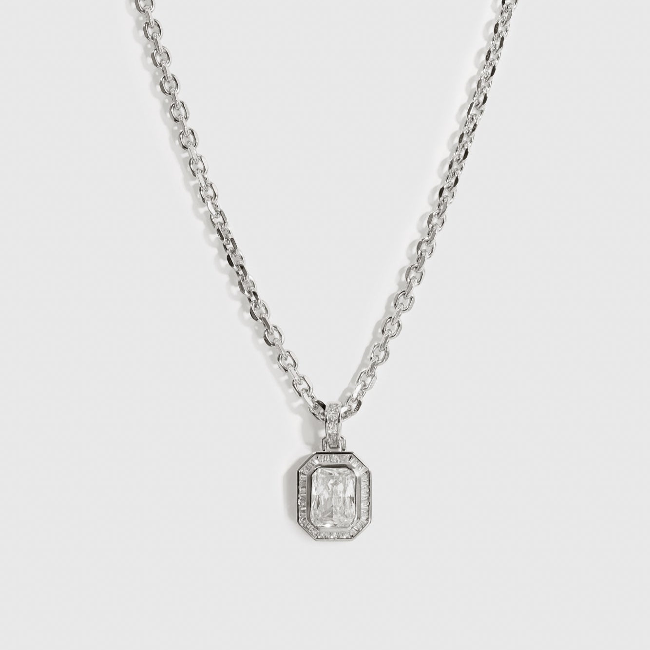 Silver plated baguette pavé pendant necklace with cubic zirconia, shown on a plain background.