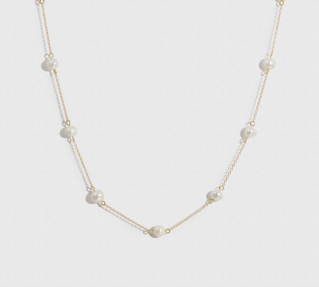 14k gold plated sterling silver 925 pearls by the yard necklace with freshwater pearls, shown on a plain background.