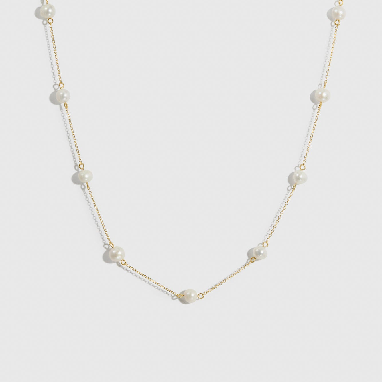 14k gold plated sterling silver 925 pearls by the yard necklace with freshwater pearls, shown on a plain background.
