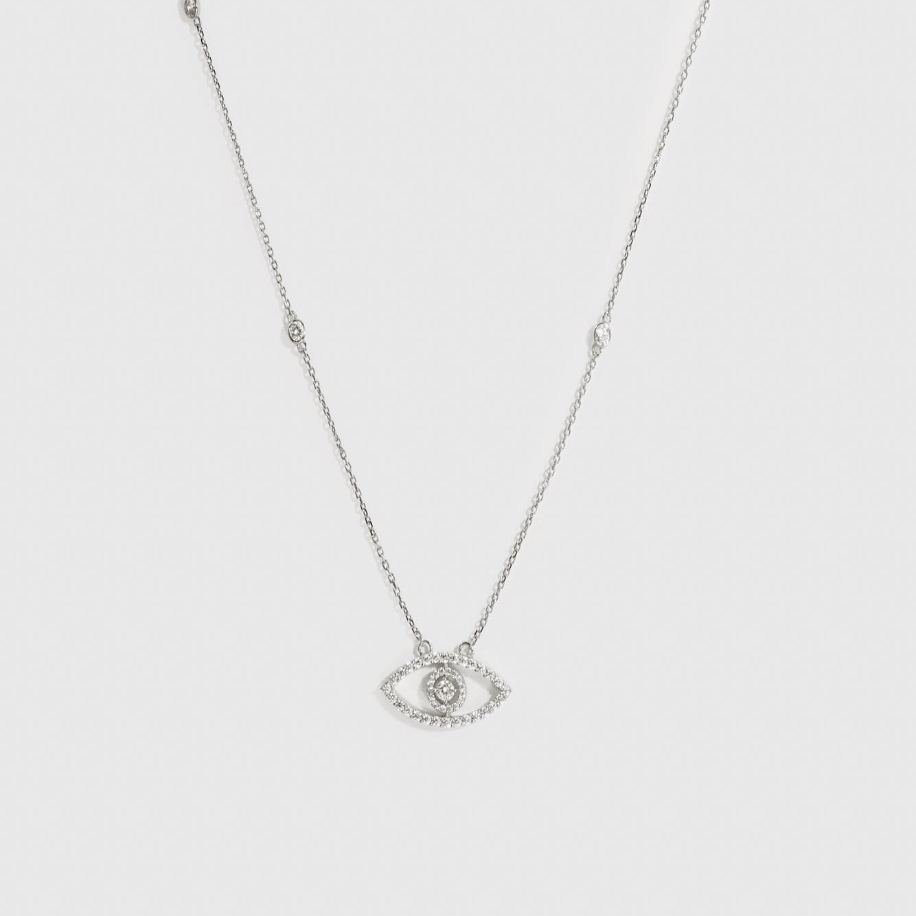 Sterling silver 925 evil eye pavé necklace with cubic zirconia, shown on a plain background.