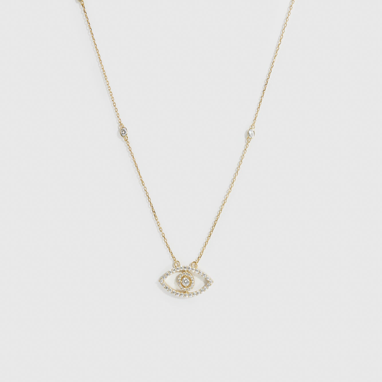 14k gold plated sterling silver 925 evil eye pavé necklace with cubic zirconia, shown on a plain background.