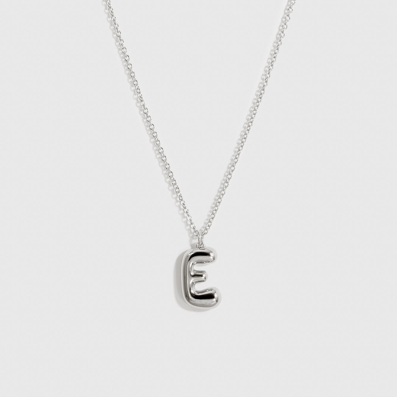 Sterling silver 925 liquid bubble letter pendant necklace, shown on a plain background.