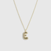 14k gold plated sterling silver 925 liquid bubble letter pendant necklace, shown on a plain background.