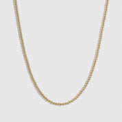 14k gold plated small beaded necklace, shown on a plain background.