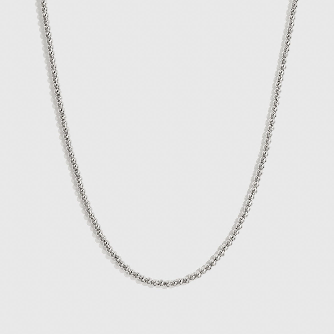 Silver plated small beaded necklace, shown on a plain background.