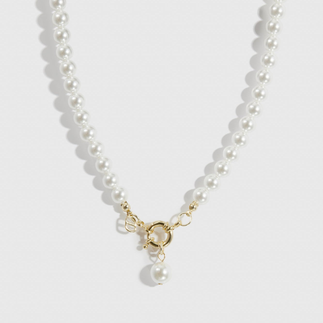 14k gold plated single row pearl choker with pearls, shown on a plain background.