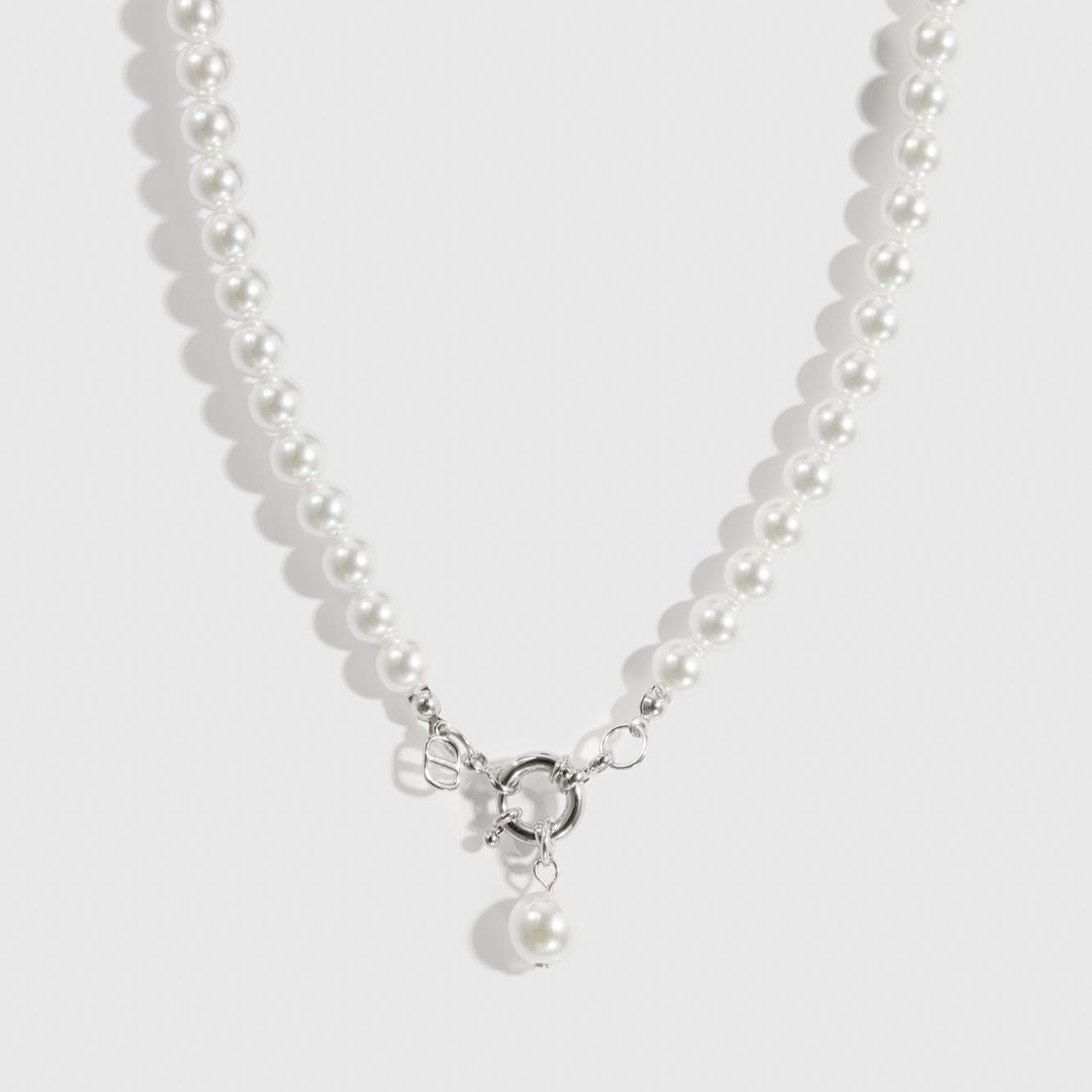 Silver plated single row pearl choker with pearls, shown on a plain background.