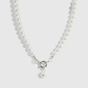 Silver plated single row pearl choker with pearls, shown on a plain background.