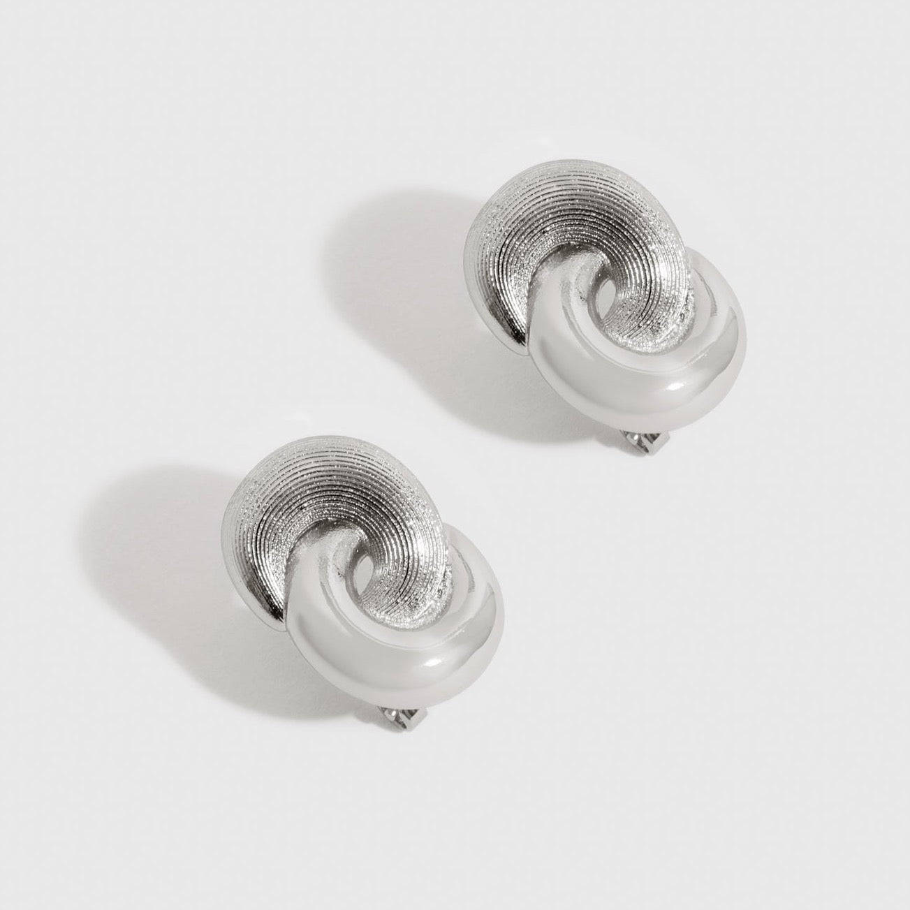 Silver plated infinity earrings, shown on a plain background.