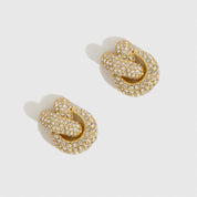 14k gold plated knot earrings with cubic zirconia, shown on a plain background.