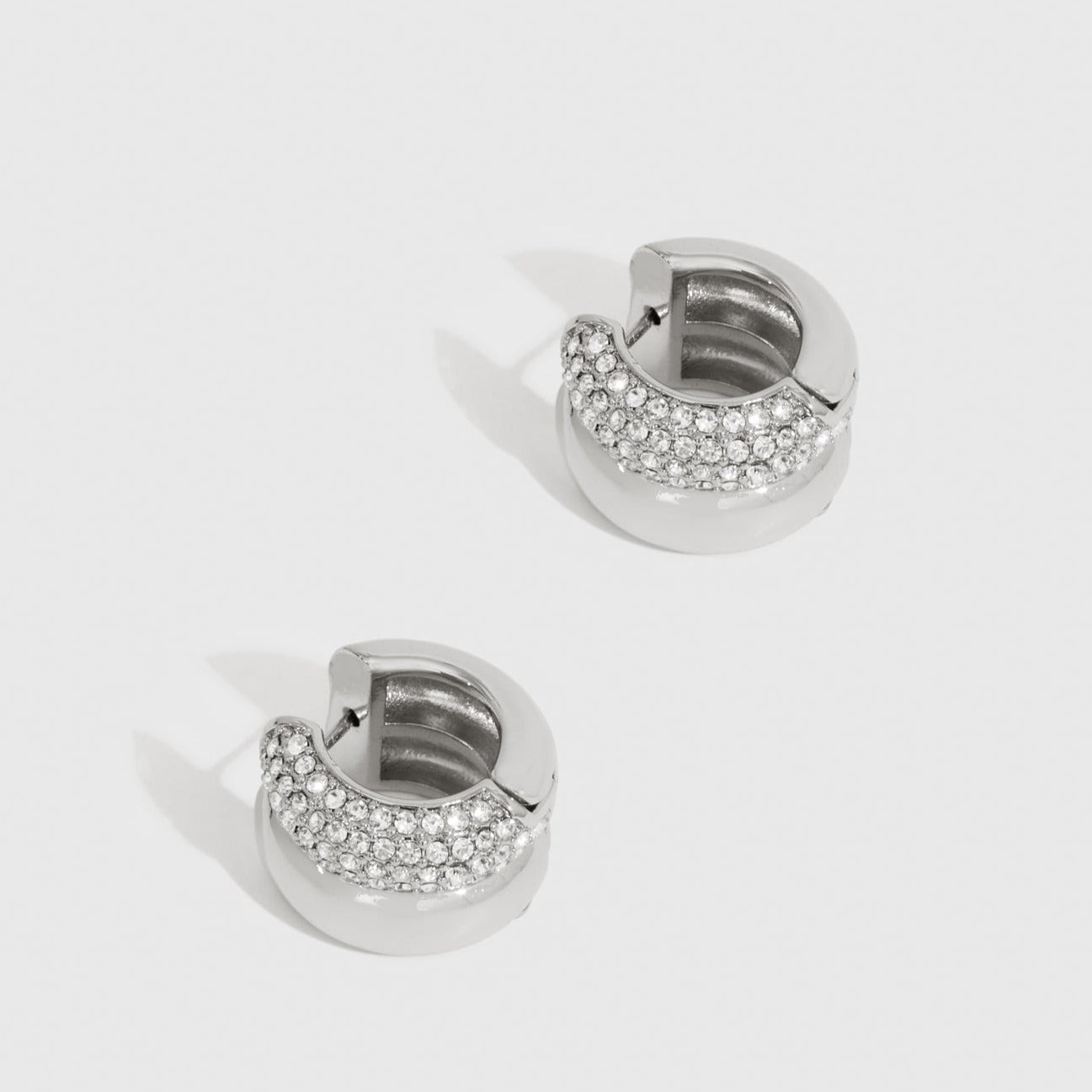 Silver plated festive hoop earrings with cubic zirconia, shown on a plain background.