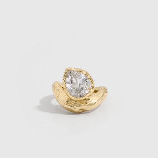 14k gold plated statement ring with a teardrop-cut cubic zirconia on a wavy organic band, shown on a plain background.